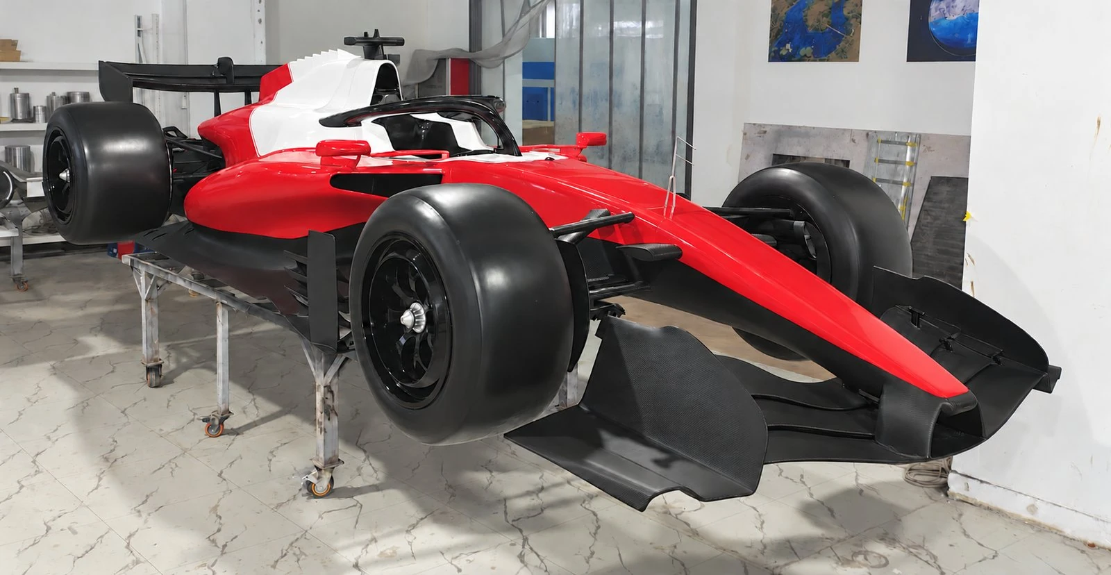 Full-size formula-style show car in red and white, front three-quarter view, graphics removed