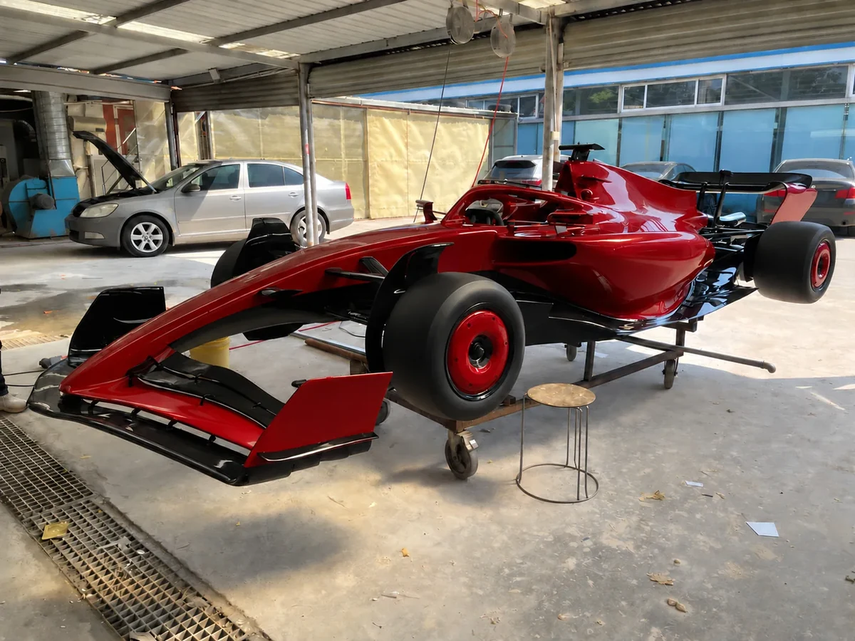 Formula-style show car in dark red and black, front three-quarter view, graphics removed